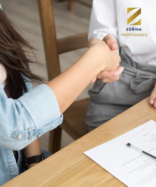 two-women-partners-handshaking-after-signing-business-contract-at-meeting